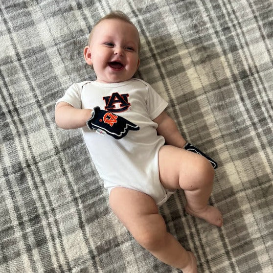 Infant wearing Auburn War Eagle baby mittens in blue