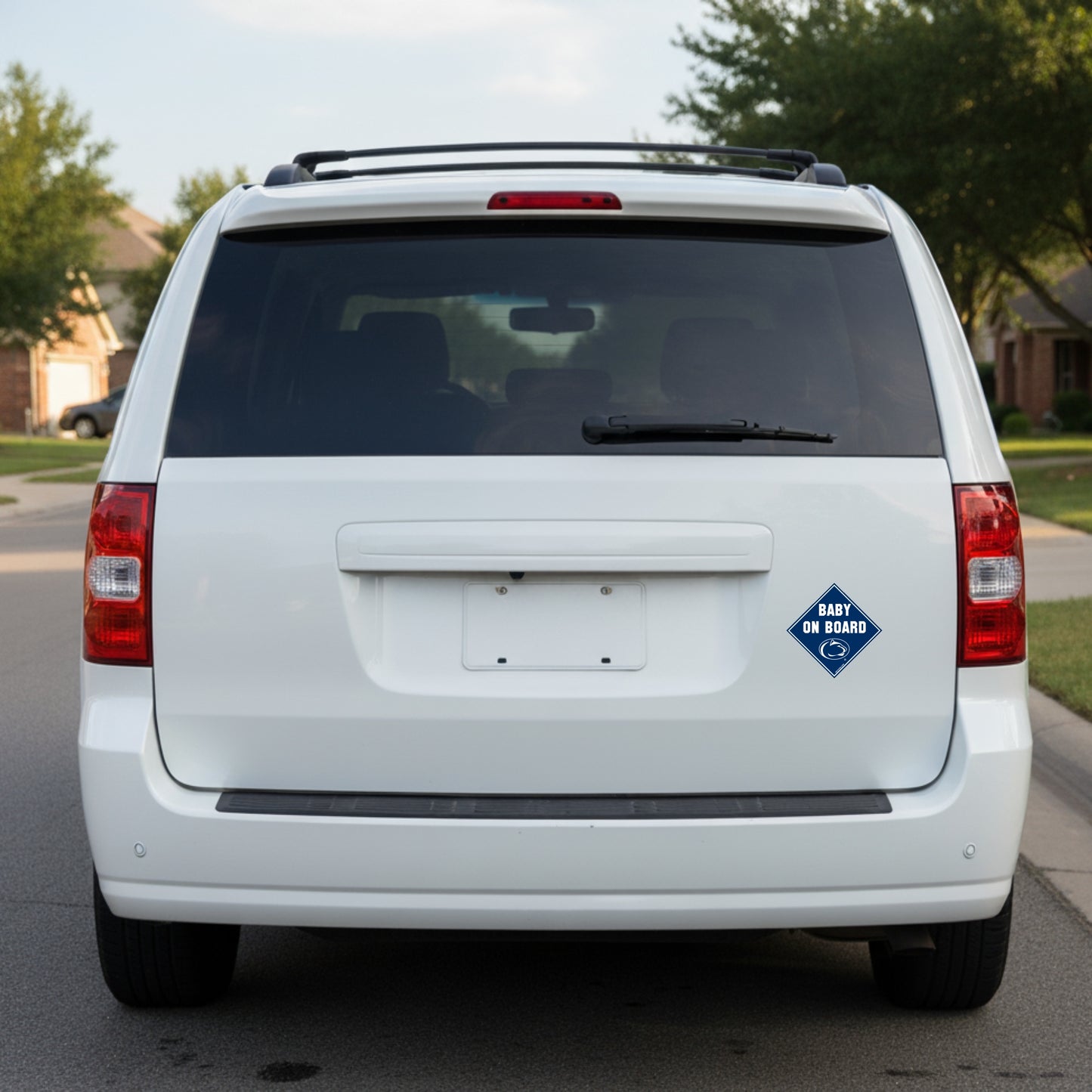 White van with a 'Baby on Board' sign on a residential street