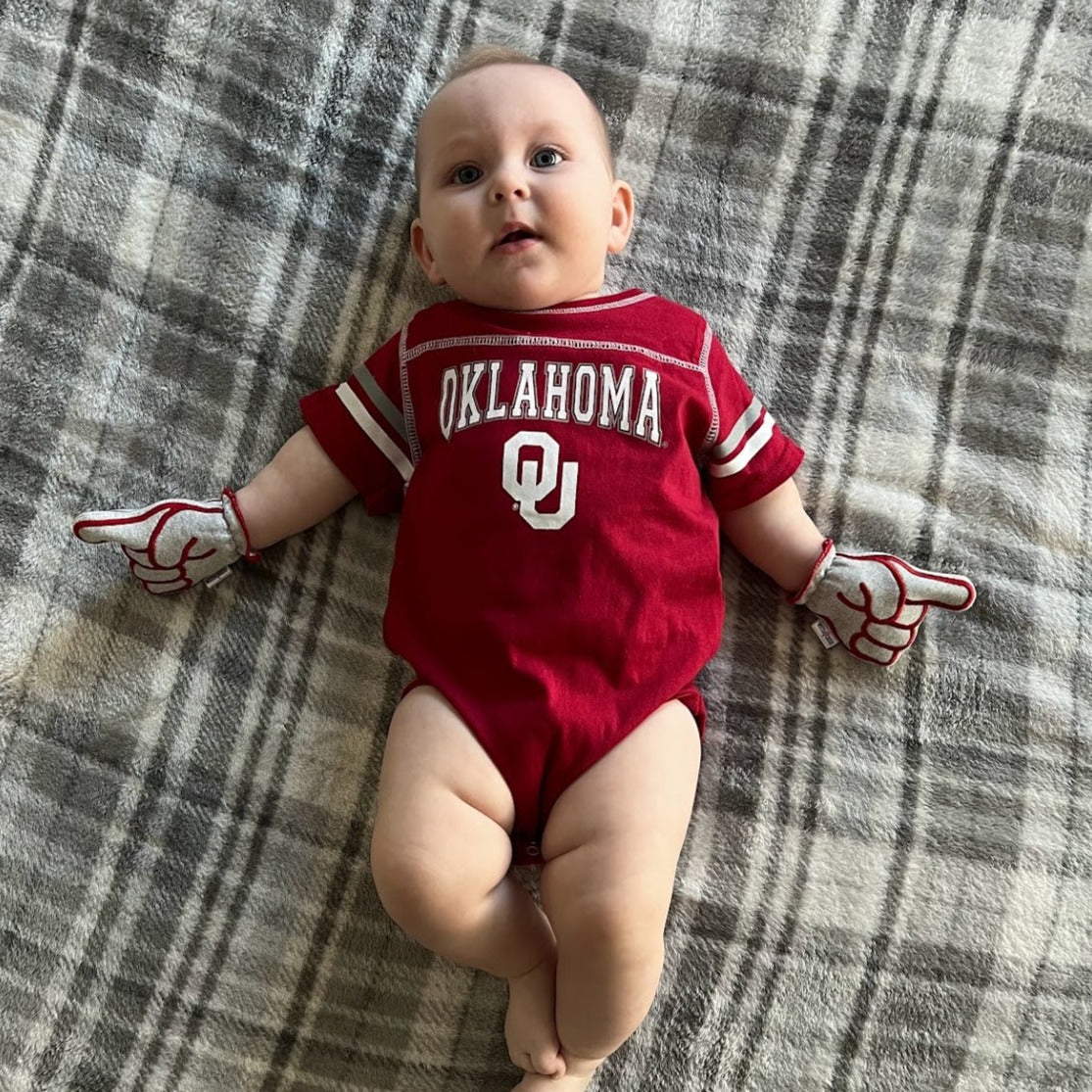 Infant wearing Oklahoma Boomer Sooner baby mittens in gray