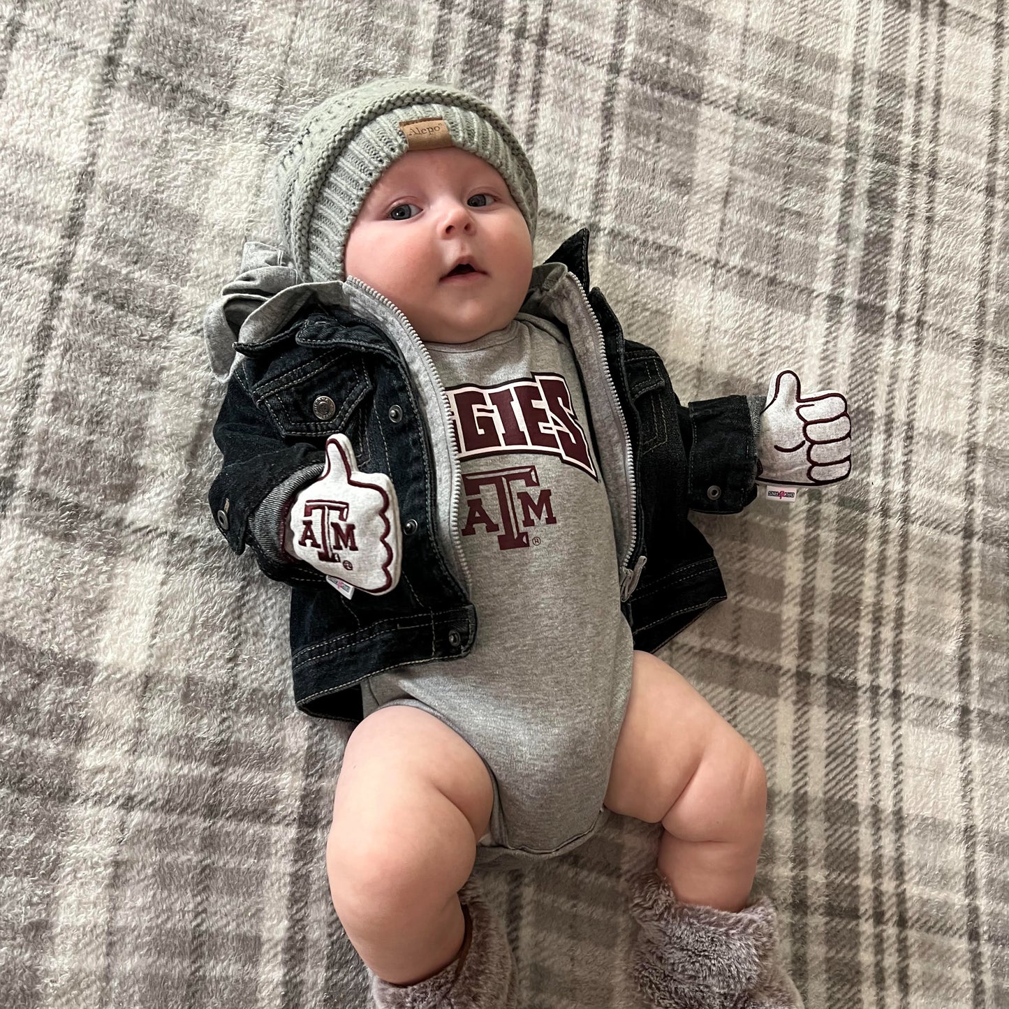Newborn wearing Texas A&M Gig Em baby mittens in gray