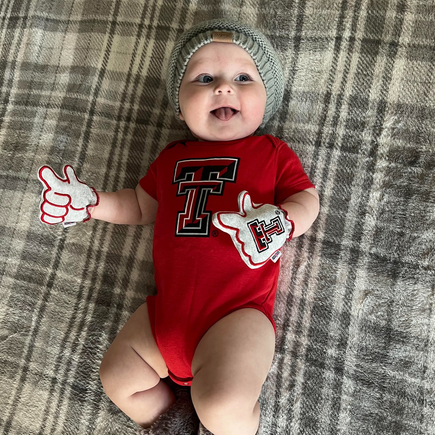 Newborn wearing Texas Tech Wreck Em baby mittens in gray