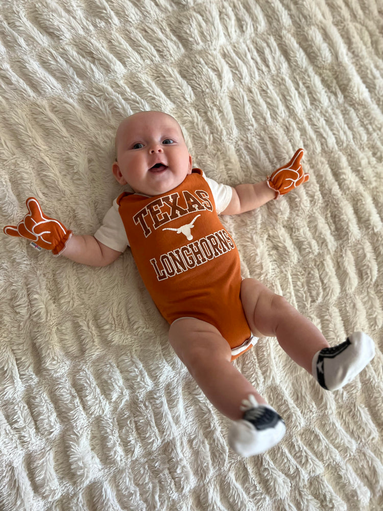 a baby wearing Day1Fans.com UT Hook Em Horns baby mittens