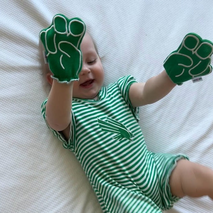 Baby wearing UNT Mean Green baby mittens in green
