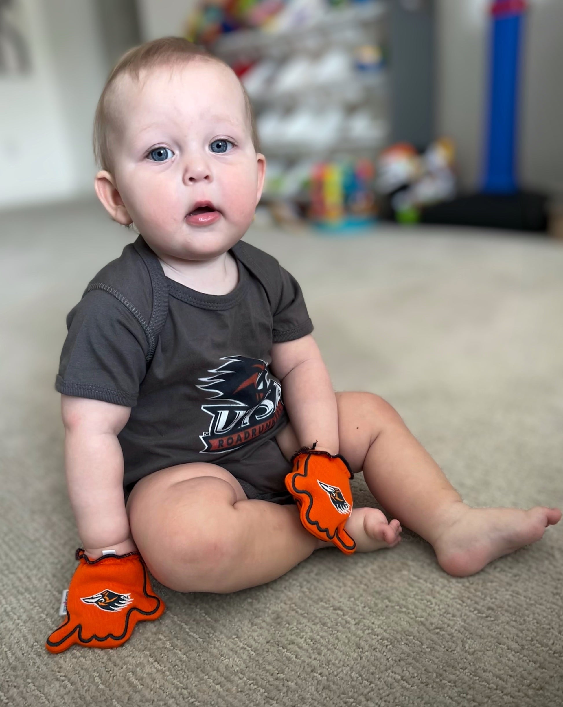 Infant wearing UTSA Go Roadrunners baby mittens in Orange