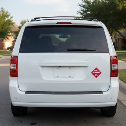 White van with a 'Baby on Board' Ohio State logo sign on the back, parked on a street.