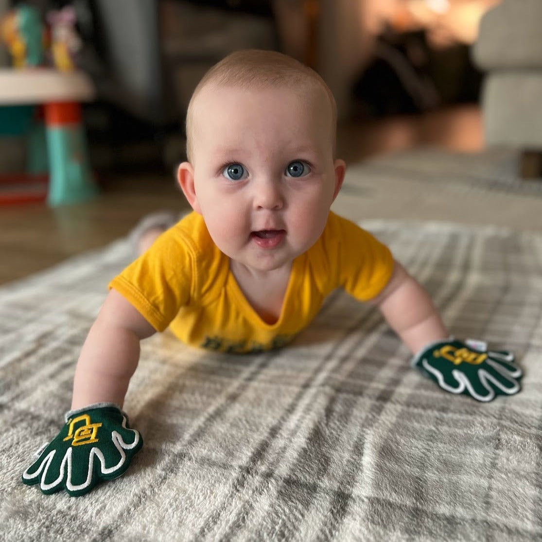 Infant wearing Baylor Sic Em baby mittens in green