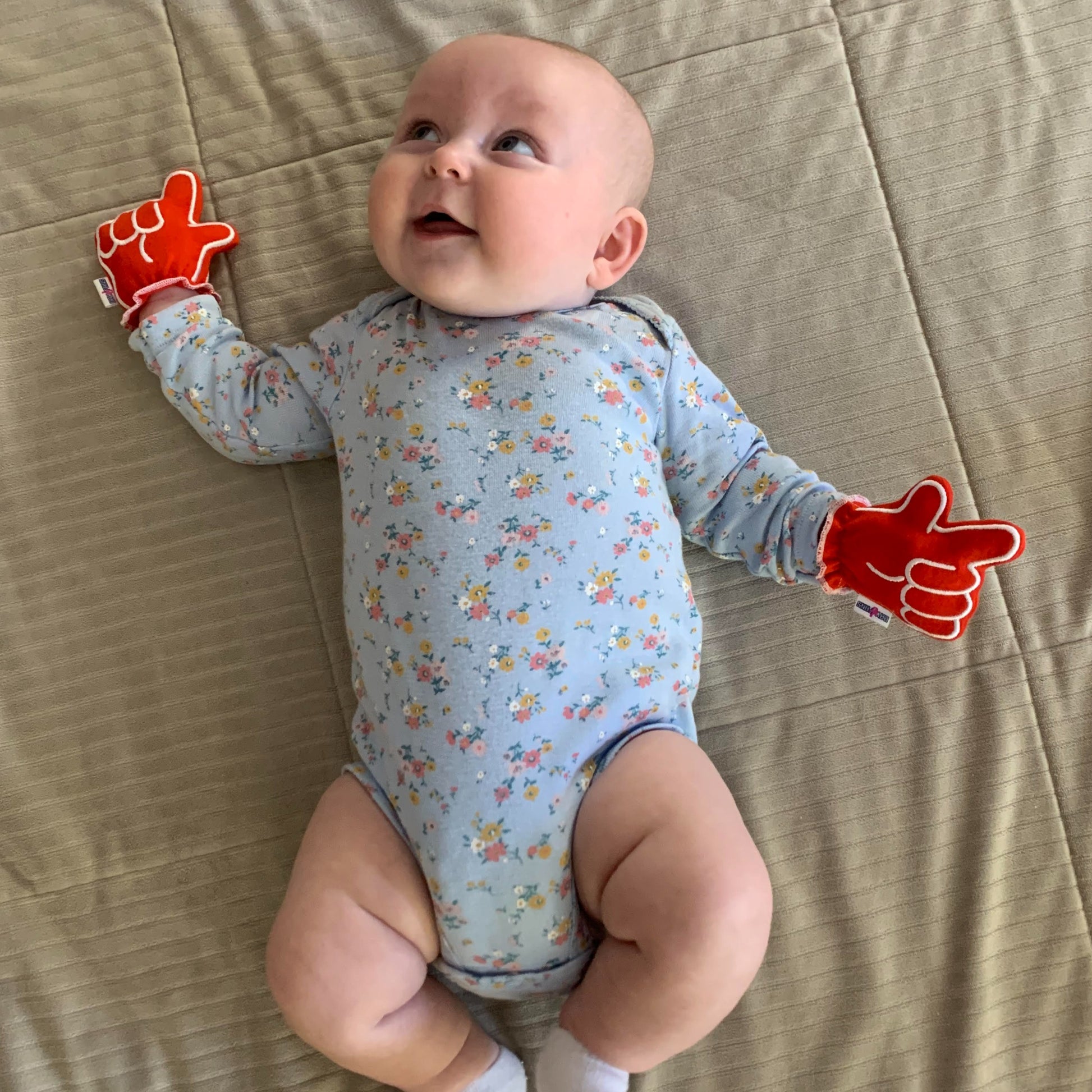 Newborn wearing Texas Tech Wreck Em baby mittens in red